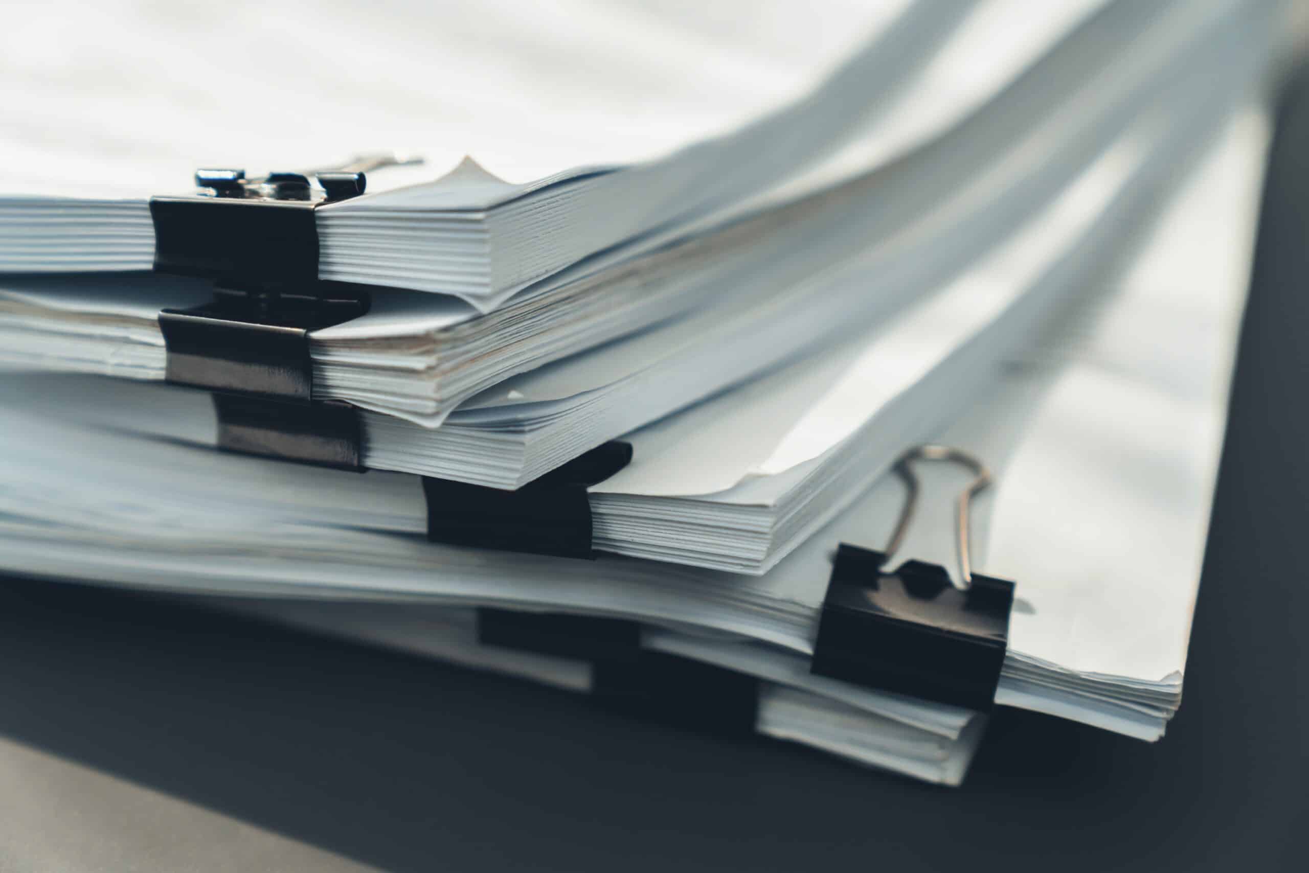 Closeup office table with organized stacked papers. equility